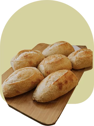 Several oval breads on a cutting board.